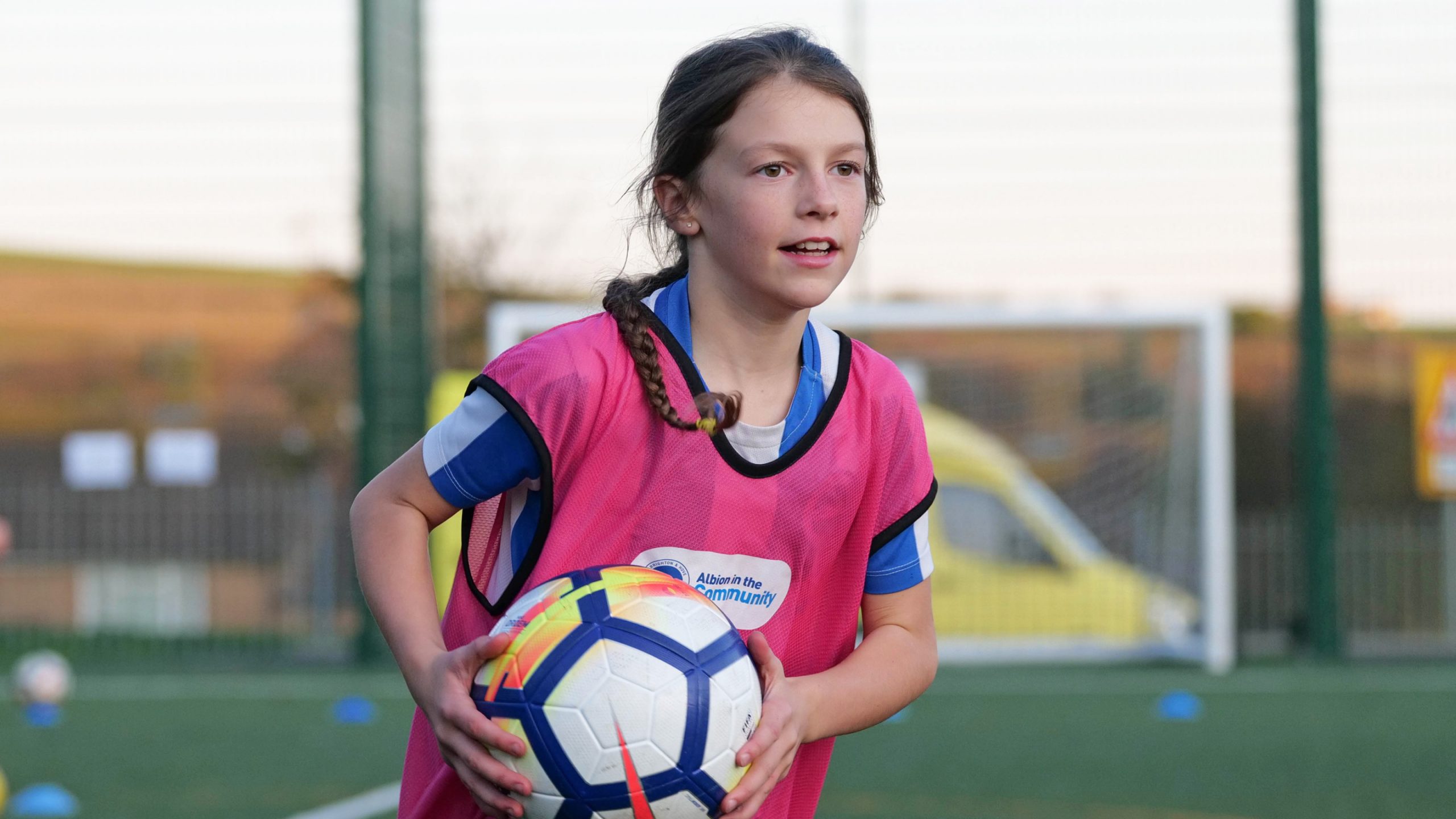 girl holding a football
