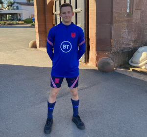 Jake Heasman, 17, wearing his England football kit